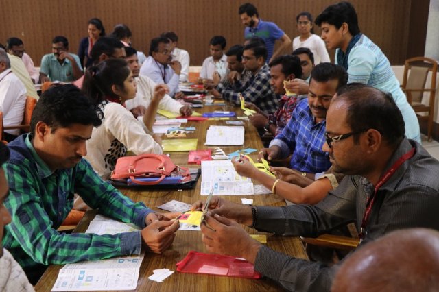Teachers assembling the foldscope.